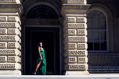 fashion model in green poses in archway