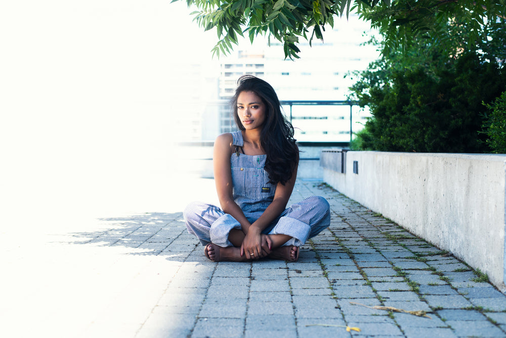 fashion model in overalls crosses legs