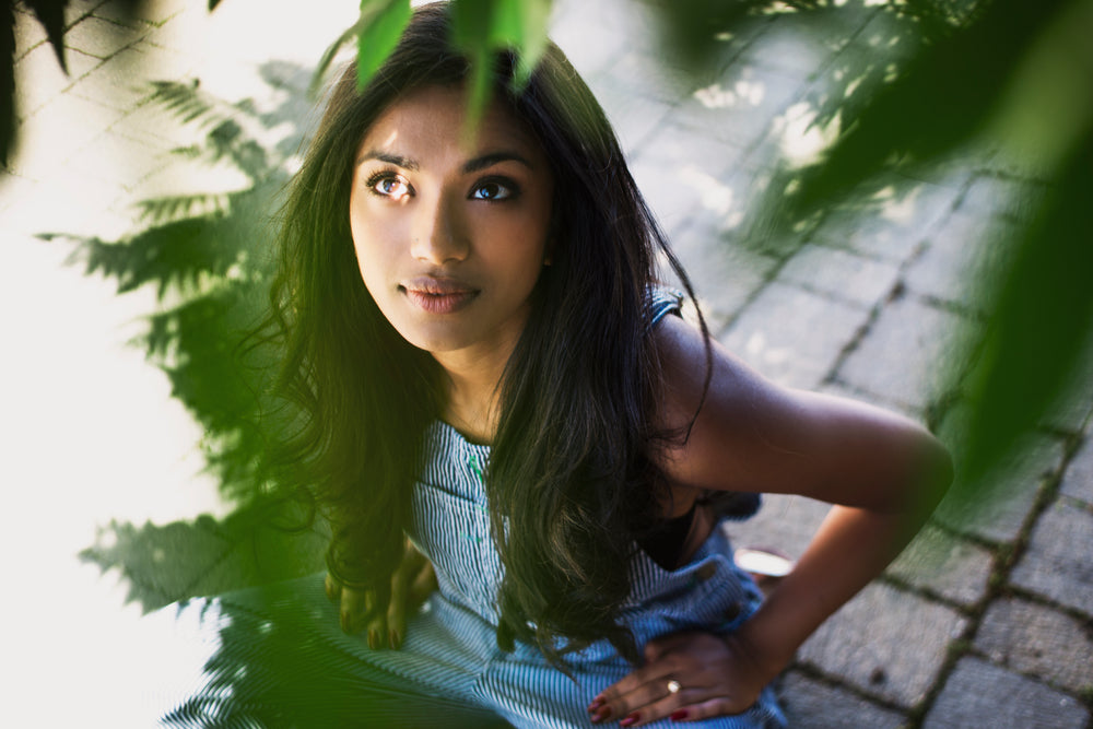 fashion model looking up through trees