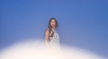 fashion model on blue wall with lens flair