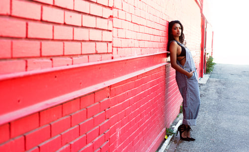 fashion model woman leans on wall