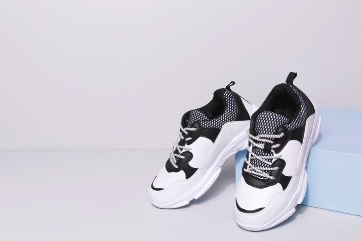 Black and white sneakers in a studio