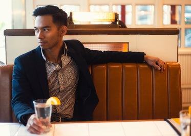 fashionable man sits in booth