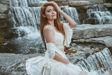 fashionable woman by waterfall