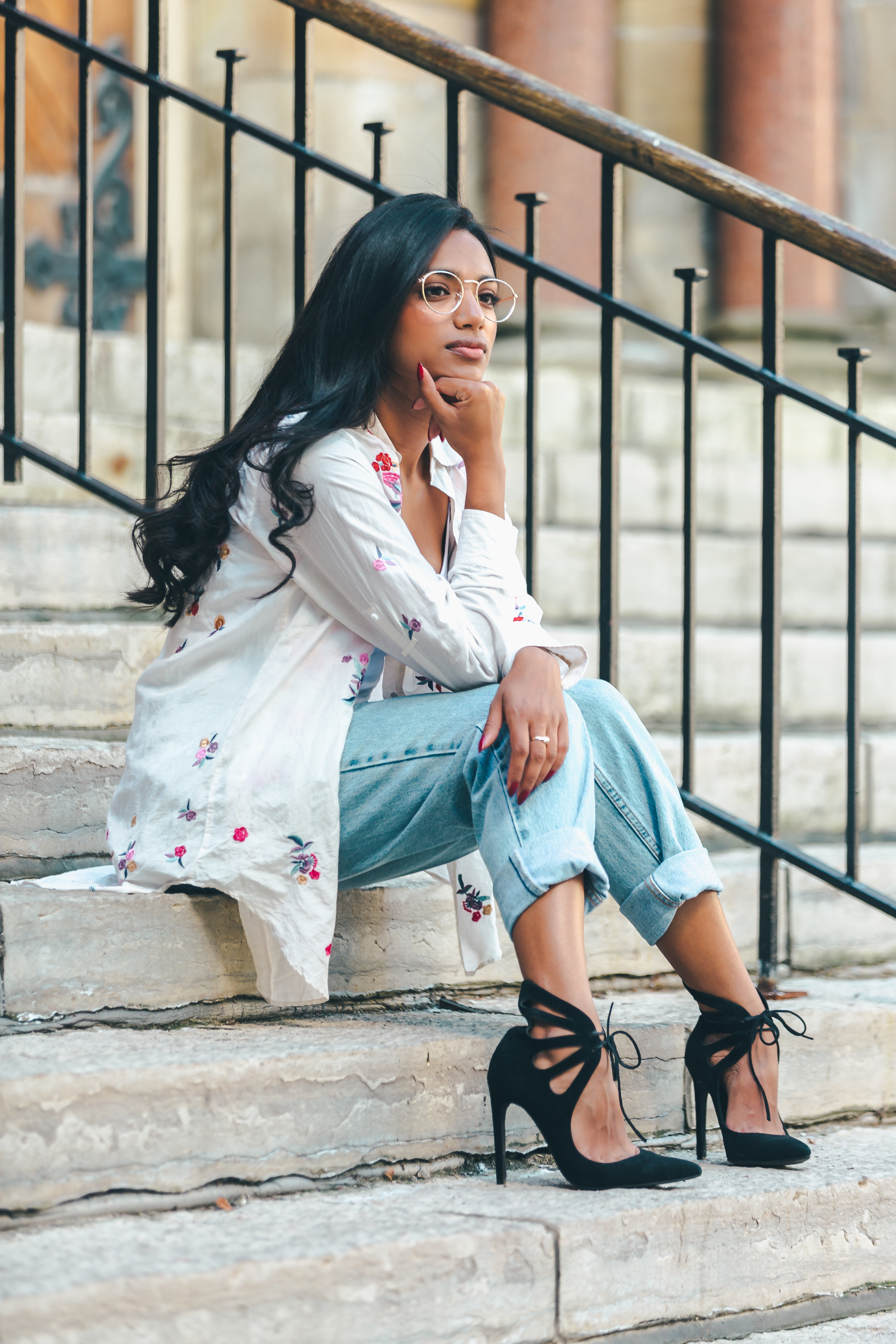 Fashionable Woman Sitting On Stairs