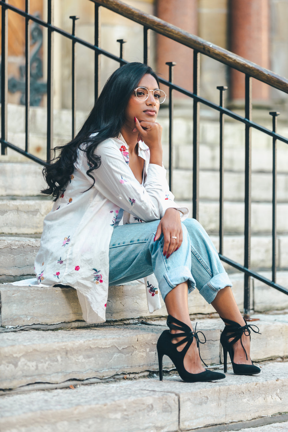 fashionable woman sitting on stairs