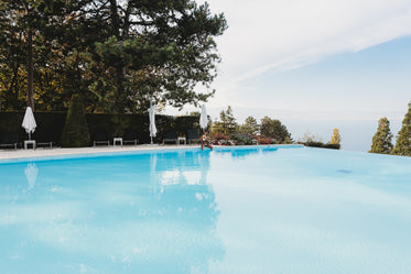 father and child by infinity pool