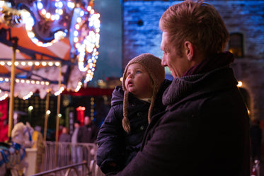 father and daughter watching lights