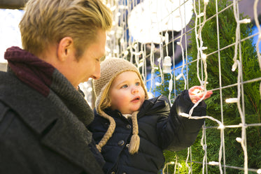 father and daughter with holiday lights