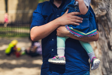 father carrying daughter