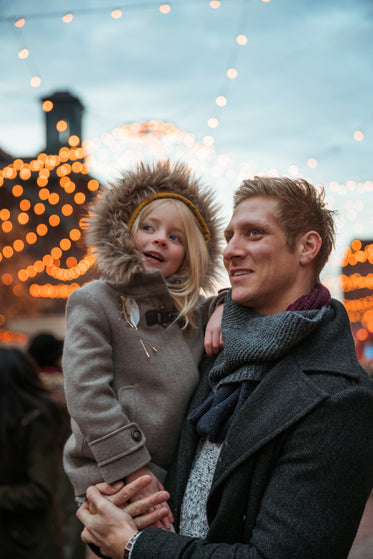 father daughter on holiday lights