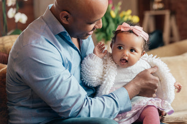 father holding baby daughter