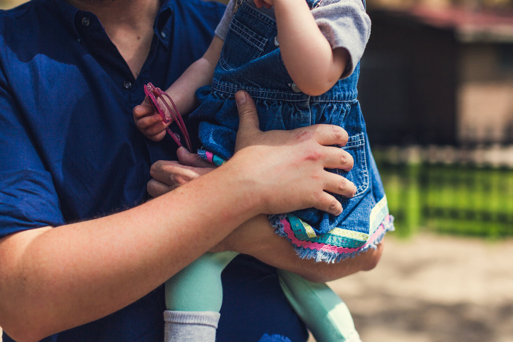 father holding baby girl