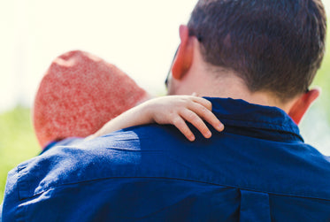 father holding daughter