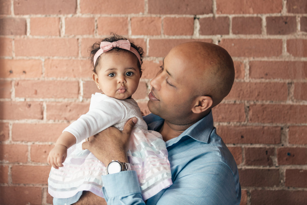 father looking lovingly at baby daughter