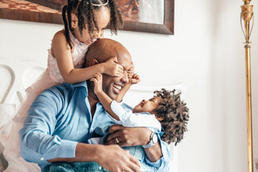 father plays with son and daughter