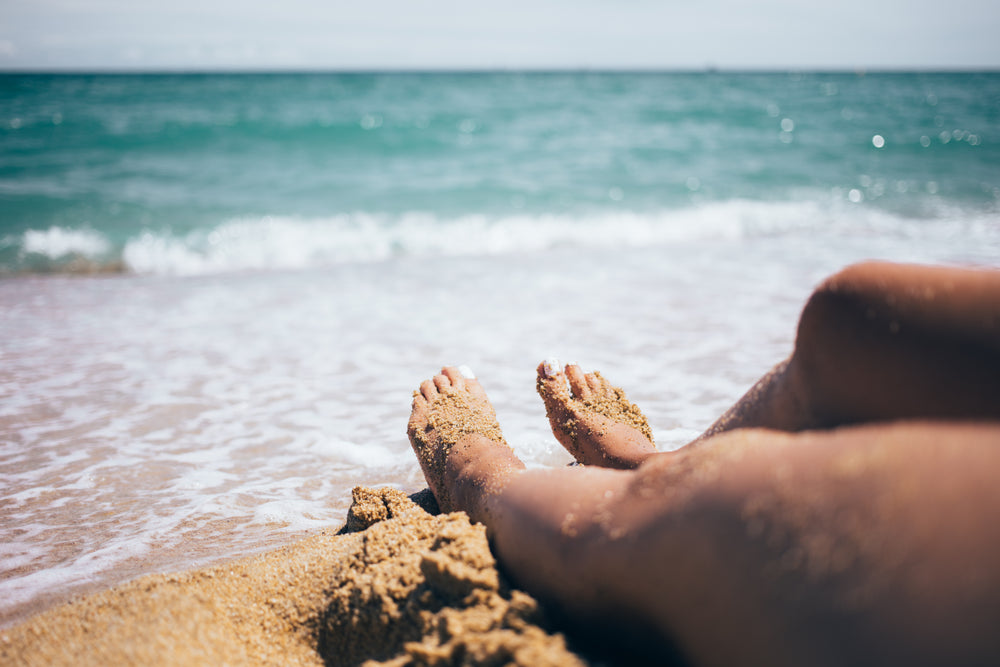 feet at waters edge