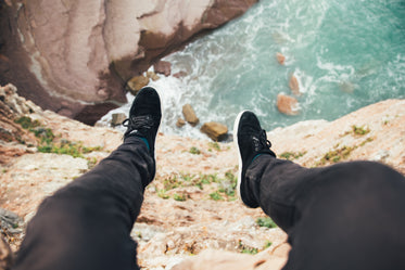 feet hanging over cliff