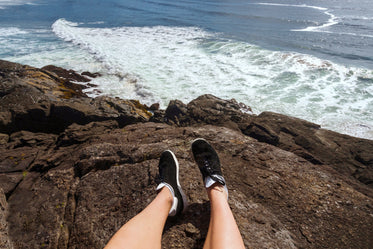 feet on rocky shore