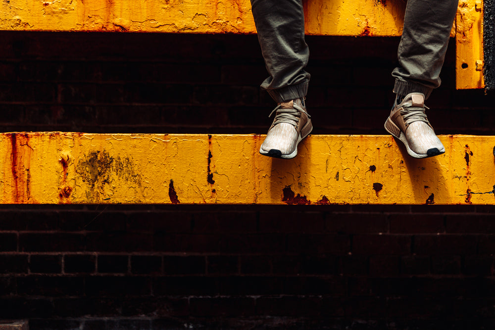 feet on yellow beam