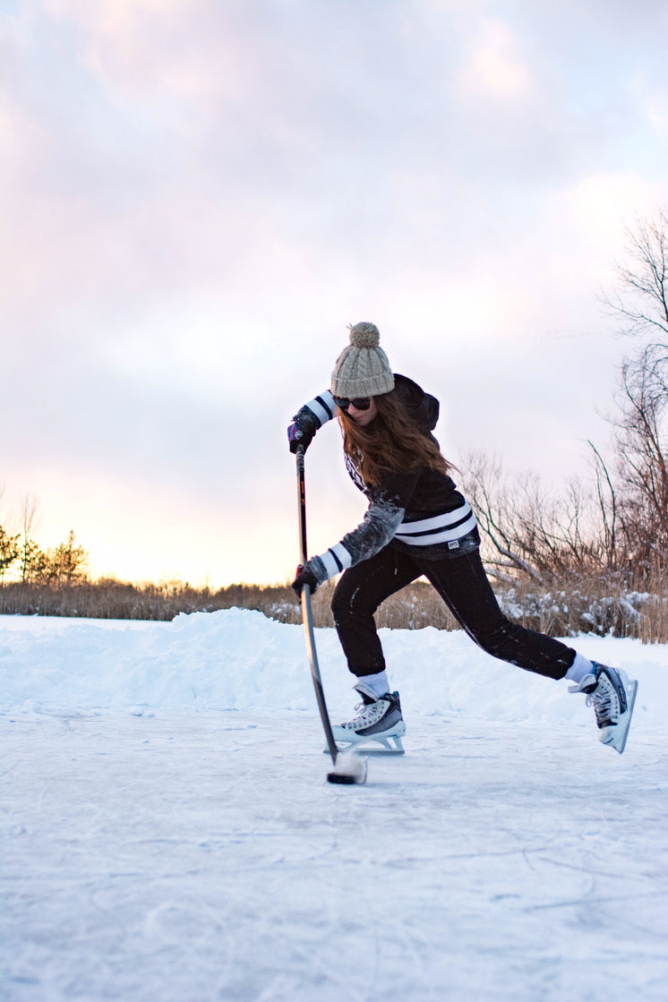 Female Hockey Player Practicing Stick Handling On Frozen Lake