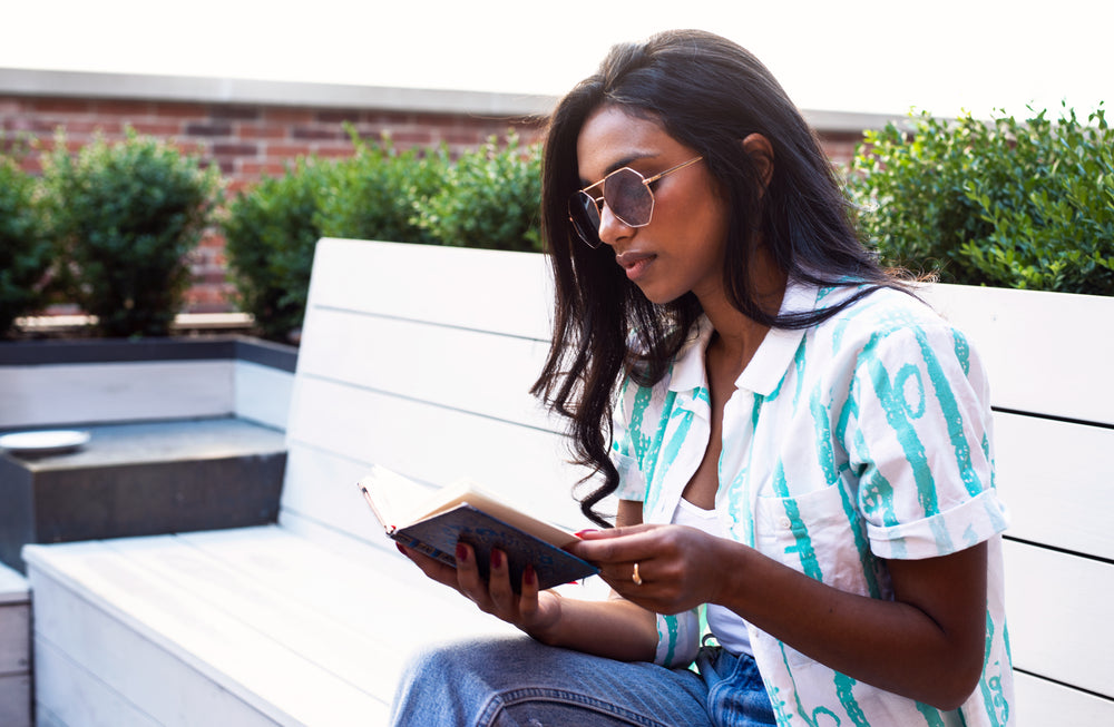 female model poses and reads