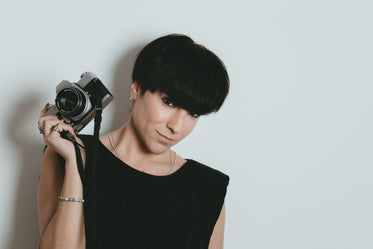 female photographer holds up her camera