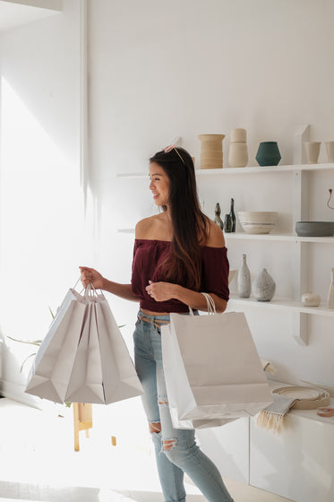 female with white shopping bags