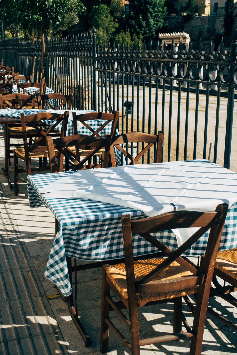 fence lined with patio tables and chairs