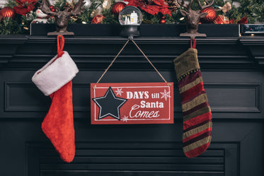festive holiday mantle with sign counting down to christmas