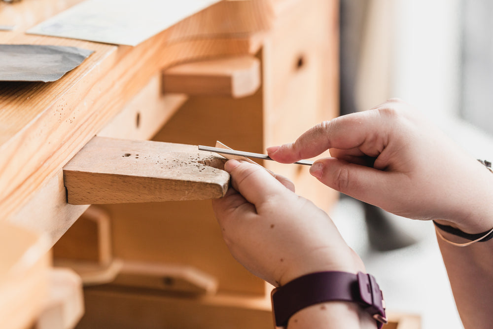 filing wood on a work bench