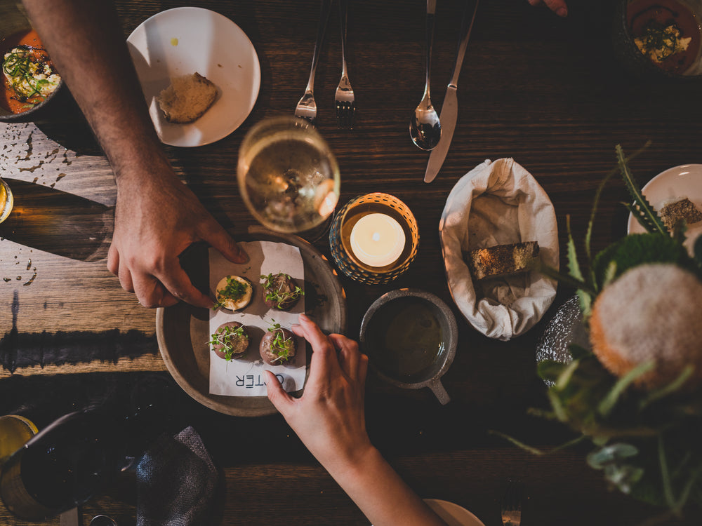 finger food and drinks on dark wood