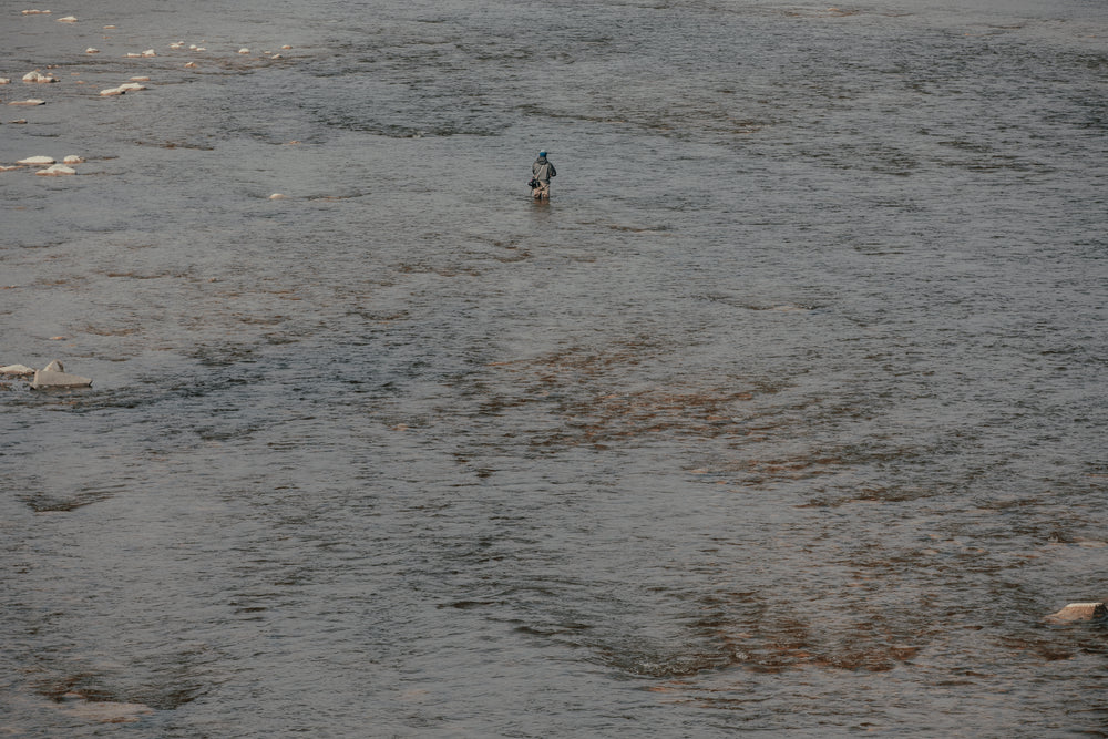 fisherman surrounded by water