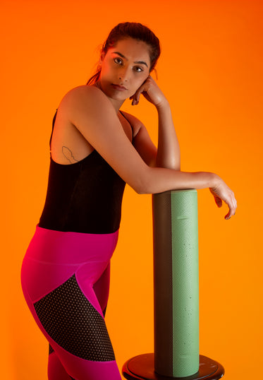 fitness model rests against foam roller