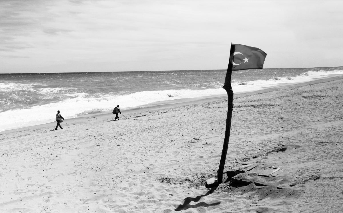 国旗插在沙滩上的木棍上
