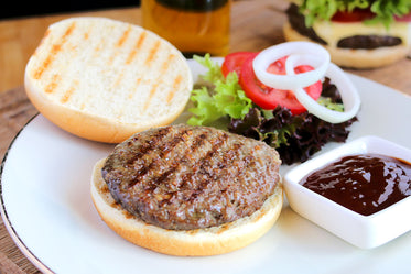 flame broiled hamburger with garnishes