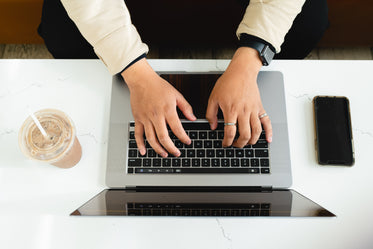 flat lay of hands typing on a keyboard