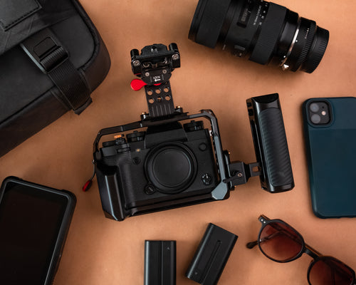 flatlay of a camera surrounded by camera equipment