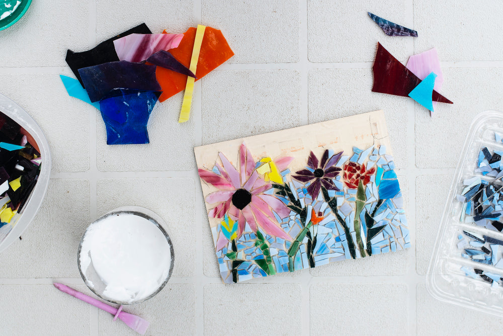 flatlay of a floral mosaic surrounded by glass pieces