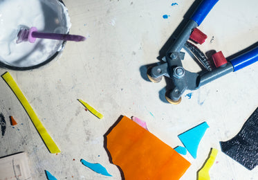 flatlay of a mosaic artists tools with cut glass