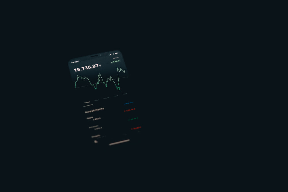 flatlay of a small screen showing graphs and numbers