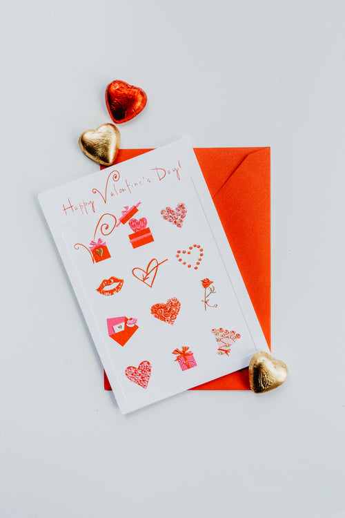 flatlay of a valentines day card with foil chocolate hearts