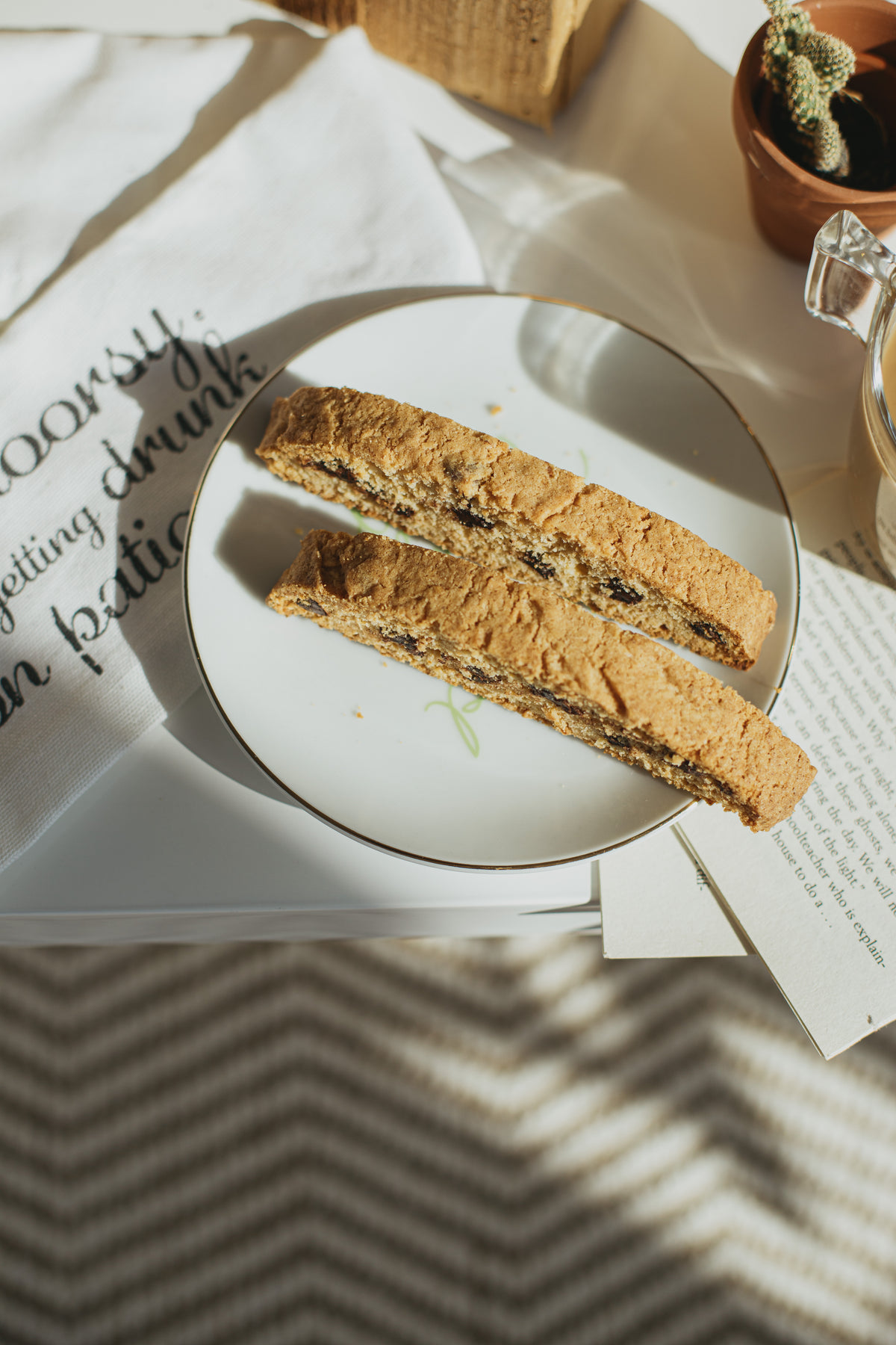 flatlay of a white plate with fresh biscotti on a table
