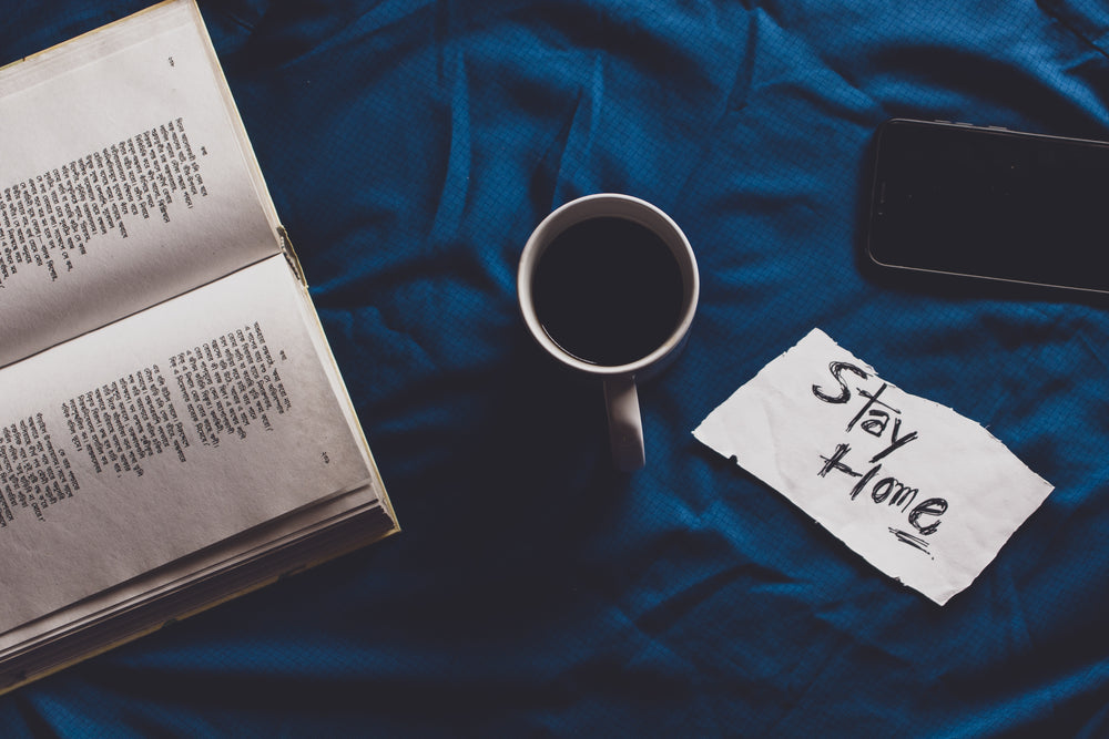 flatlay of book with coffee and phone