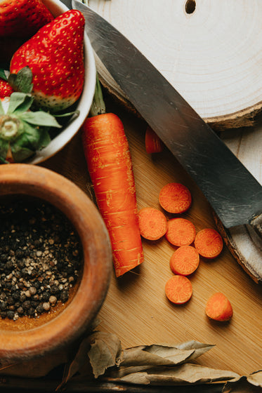 flatlay of fruit and vegetables on a wooden cutting board