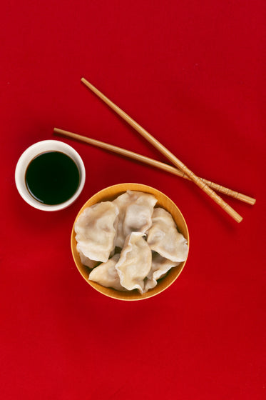 Flatlay With Dumplings And Chopsticks On Red Background