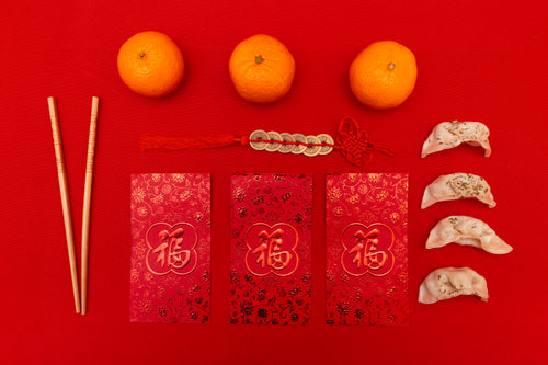 Flatlay With Red Cards With Gold Coins On Red Rope