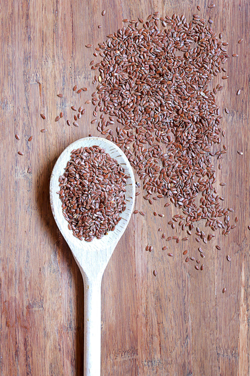 flax seeds in wooden spoon
