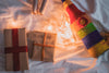 flay lay of gifts string lights and a bottle