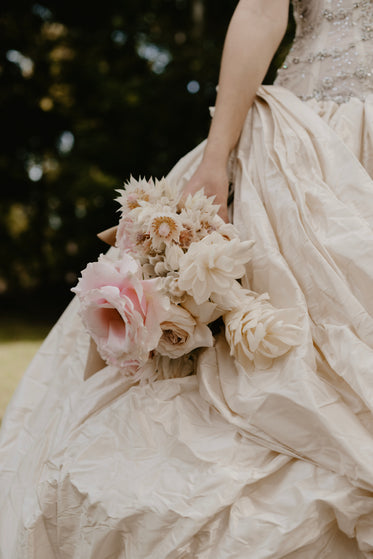 flowing gowns and pink bridal bouquet